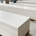 Stacks of flat MgO boards prepared for duct component specification review
